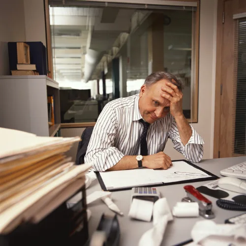 Business owner overwhelmed at his desk